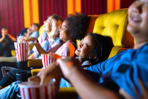 kids watching a movie in theater setting 