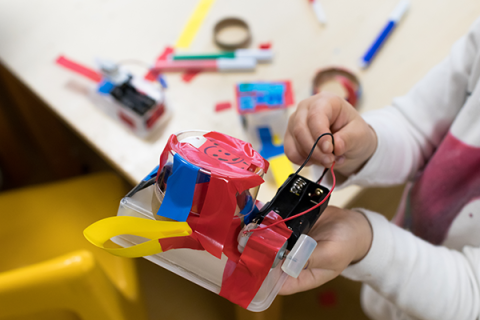 child tinkering with engineering project