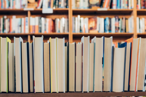 fore-edge view of shelved books with filled bookcases in background