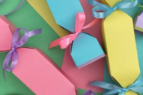 colorful paper folded into small gift boxes shaped like candies