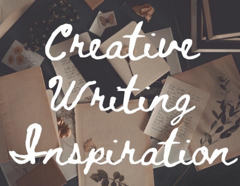 text "Creative Writing Inspiration" in white cursive font over a backdrop of  a journal and loose journal pages