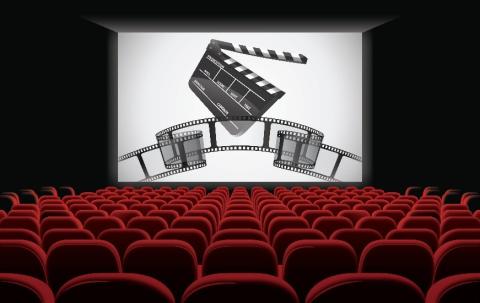 Empty theater with film and clapboard showing on screen.