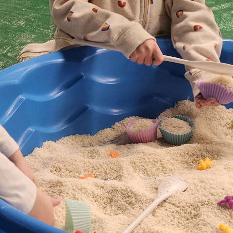 Children playing in sandbox.