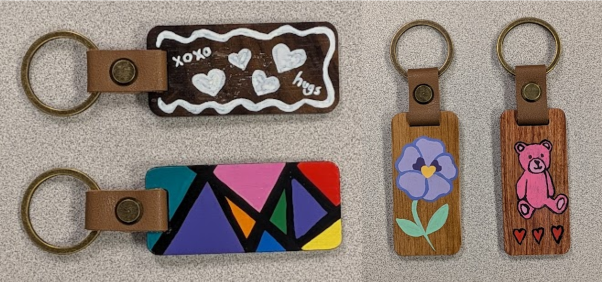 four woodgrain keychains with painted designs
