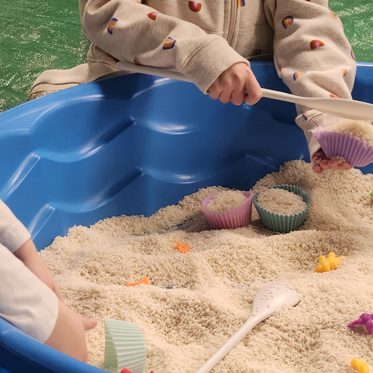 Children playing in sandbox.